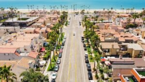 Aerial view of 17th Street and Pacific Coast Highway in Huntington Beach with the coastline and Pacific Ocean in the background